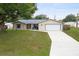 Single Gathering home with neutral siding, a red front door and manicured lawn at 2910 Yule Tree Dr, Edgewater, FL 32141