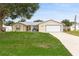 Inviting single-story home with a classic design, featuring a well-manicured lawn and attached garage at 2910 Yule Tree Dr, Edgewater, FL 32141