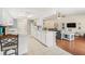 Bright kitchen with white cabinets, tile floors, and bar seating open to the living room at 2910 Yule Tree Dr, Edgewater, FL 32141