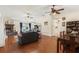 Open-concept living space with hardwood floors, featuring a living room, dining area, and access to the kitchen at 2910 Yule Tree Dr, Edgewater, FL 32141