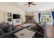 Cozy living room featuring a fireplace, hardwood floors, comfortable seating, and a sliding glass door to the patio at 2910 Yule Tree Dr, Edgewater, FL 32141