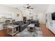 Spacious living room featuring hardwood floors, vaulted ceilings, comfortable seating, and views into the kitchen and dining area at 2910 Yule Tree Dr, Edgewater, FL 32141