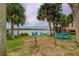 Waterfront backyard offers picnic tables and Adirondack chairs for enjoying scenic views at 33 Camellia Dr, Ormond Beach, FL 32176
