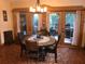 Charming dining room with rustic decor, a unique round table, and access to an outdoor patio at 33 Camellia Dr, Ormond Beach, FL 32176