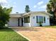 Charming home featuring a brick driveway, well-maintained lawn, and freshly painted white exterior at 33 Camellia Dr, Ormond Beach, FL 32176