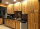 Spacious kitchen showcasing custom wood cabinetry, stainless steel appliances, and elegant dark countertops at 33 Camellia Dr, Ormond Beach, FL 32176