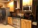 Well-equipped kitchen featuring stainless steel appliances, custom wood cabinets, and contrasting dark countertops at 33 Camellia Dr, Ormond Beach, FL 32176