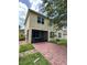 Back exterior view of home showing a screened-in porch and brick-paved patio at 3660 Daydream Pl, St Cloud, FL 34772