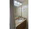 Well-lit bathroom vanity with a decorative mirror and granite countertops at 3660 Daydream Pl, St Cloud, FL 34772