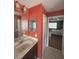 Bathroom featuring a vanity with a mirror, a dark wood cabinet, and a view of the bedroom at 3660 Daydream Pl, St Cloud, FL 34772