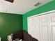Bright bedroom with a built-in closet and green walls, offering ample storage at 3660 Daydream Pl, St Cloud, FL 34772