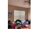 Relaxing bedroom with a ceiling fan, window and comfortable black chair at 3660 Daydream Pl, St Cloud, FL 34772