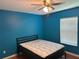 Bedroom featuring blue walls, a window, a bed, and a ceiling fan at 3660 Daydream Pl, St Cloud, FL 34772
