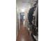 Walk-in closet with hanging clothes and overhead storage leading to the bedroom at 3660 Daydream Pl, St Cloud, FL 34772