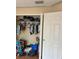 A standard closet behind white doors with clothes and clutter at 3660 Daydream Pl, St Cloud, FL 34772