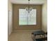 Bright dining area featuring a large window, neutral walls, and sleek tile flooring at 3660 Daydream Pl, St Cloud, FL 34772