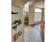 Hallway with a nook, featuring tile flooring and neutral tones, connecting different parts of the home at 3660 Daydream Pl, St Cloud, FL 34772