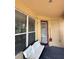 Covered porch with neutral colored sofa and a view of the yard at 3660 Daydream Pl, St Cloud, FL 34772