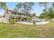 Spacious backyard with large pool, covered patio and mature trees at 428 Pelican Bay Dr, Daytona Beach, FL 32119