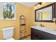 Bathroom features a single sink vanity, tile floors, and a view to the outside at 428 Pelican Bay Dr, Daytona Beach, FL 32119