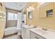 Bright bathroom with dual sinks, tiled floor, vanity, tub-shower combo, and linen closet at 428 Pelican Bay Dr, Daytona Beach, FL 32119