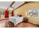 Bright bedroom with vaulted ceiling, wood beams, ceiling fan, and two windows with lovely views at 428 Pelican Bay Dr, Daytona Beach, FL 32119