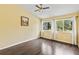 Bedroom featuring wood floors, a ceiling fan, and three sunny windows with views at 428 Pelican Bay Dr, Daytona Beach, FL 32119