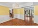 Elegant dining room with hardwood floors, wainscoting and open view to adjacent living spaces at 428 Pelican Bay Dr, Daytona Beach, FL 32119