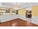 Bright dining room with hardwood floors, white wainscoting, and modern light fixture at 428 Pelican Bay Dr, Daytona Beach, FL 32119