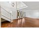 Open foyer area with hardwood floors, staircase and natural light streaming through windows at 428 Pelican Bay Dr, Daytona Beach, FL 32119