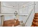 Foyer featuring a hardwood staircase, white railing and an open concept space with natural light at 428 Pelican Bay Dr, Daytona Beach, FL 32119
