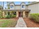 Inviting home with a charming red door, stone accents, and lovely landscaping at 428 Pelican Bay Dr, Daytona Beach, FL 32119
