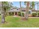 Charming home featuring a stone facade, well-manicured lawn, and inviting landscaping at 428 Pelican Bay Dr, Daytona Beach, FL 32119