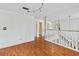 Loft featuring hardwood floors, natural light, and a white railing at 428 Pelican Bay Dr, Daytona Beach, FL 32119