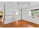 Loft featuring hardwood floors, natural light, and a white railing at 428 Pelican Bay Dr, Daytona Beach, FL 32119