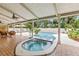 Covered outdoor living space features a pool and spa at 428 Pelican Bay Dr, Daytona Beach, FL 32119