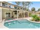 Backyard oasis features a pool with in-pool seating, and a covered patio at 428 Pelican Bay Dr, Daytona Beach, FL 32119
