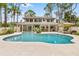 Lovely backyard with covered patio, outdoor seating and sparkling pool at 428 Pelican Bay Dr, Daytona Beach, FL 32119