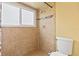 Updated shower with tile surround, mosaic accent, showerhead, and frosted window at 428 Pelican Bay Dr, Daytona Beach, FL 32119