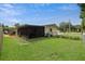 Back exterior of the home with a screened patio, view of the yard and fencing at 999 16Th St, Edgewater, FL 32132