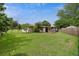 View of the home's exterior showing the spacious backyard, patio area, and well-kept lawn at 999 16Th St, Edgewater, FL 32132