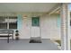 Welcoming front entrance featuring a white door, stylish accents, and a cozy bench at 999 16Th St, Edgewater, FL 32132