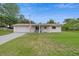 Charming single-story home boasts a well-kept lawn, garage, and a quaint front porch at 999 16Th St, Edgewater, FL 32132