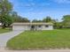 Inviting single-story home with a well-manicured lawn, garage, and a quaint front porch at 999 16Th St, Edgewater, FL 32132