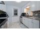 Well-lit kitchen featuring white cabinets, stainless steel appliances, and granite countertops at 999 16Th St, Edgewater, FL 32132