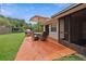 Outdoor patio area with grill, table, and umbrella for enjoying the backyard at 999 16Th St, Edgewater, FL 32132