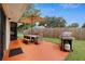 Outdoor patio featuring seating, umbrella, and a grill, perfect for entertaining at 999 16Th St, Edgewater, FL 32132
