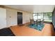 Sunroom with a table and chairs on a bright tropical rug with windows that let in the light at 999 16Th St, Edgewater, FL 32132