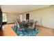Bright sunroom with a table and chairs on a bright tropical rug with windows that let in the light at 999 16Th St, Edgewater, FL 32132