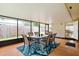 Bright sunroom featuring a table and chairs on a bright tropical rug with windows that let in the light at 999 16Th St, Edgewater, FL 32132